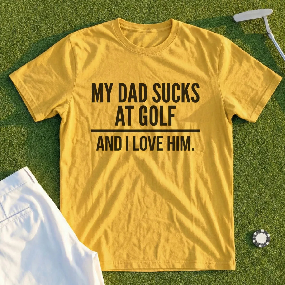 Yellow t-shirt with text "MY DAD SUCKS AT GOLF AND I LOVE HIM."
