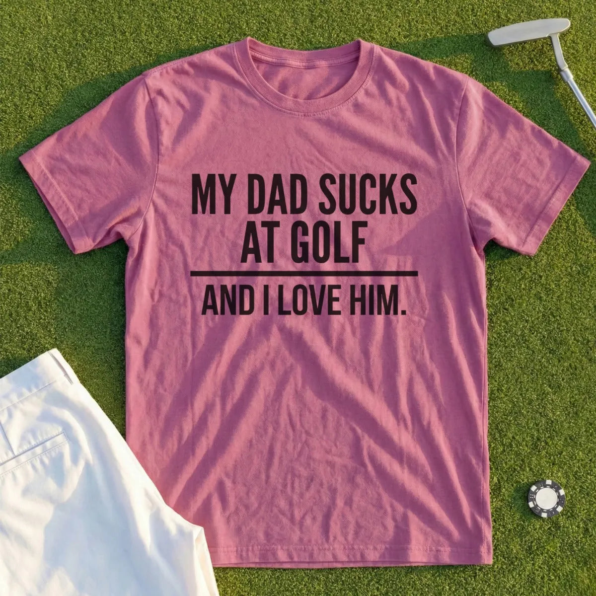 Pink t-shirt with "MY DAD SUCKS AT GOLF AND I LOVE HIM." text.