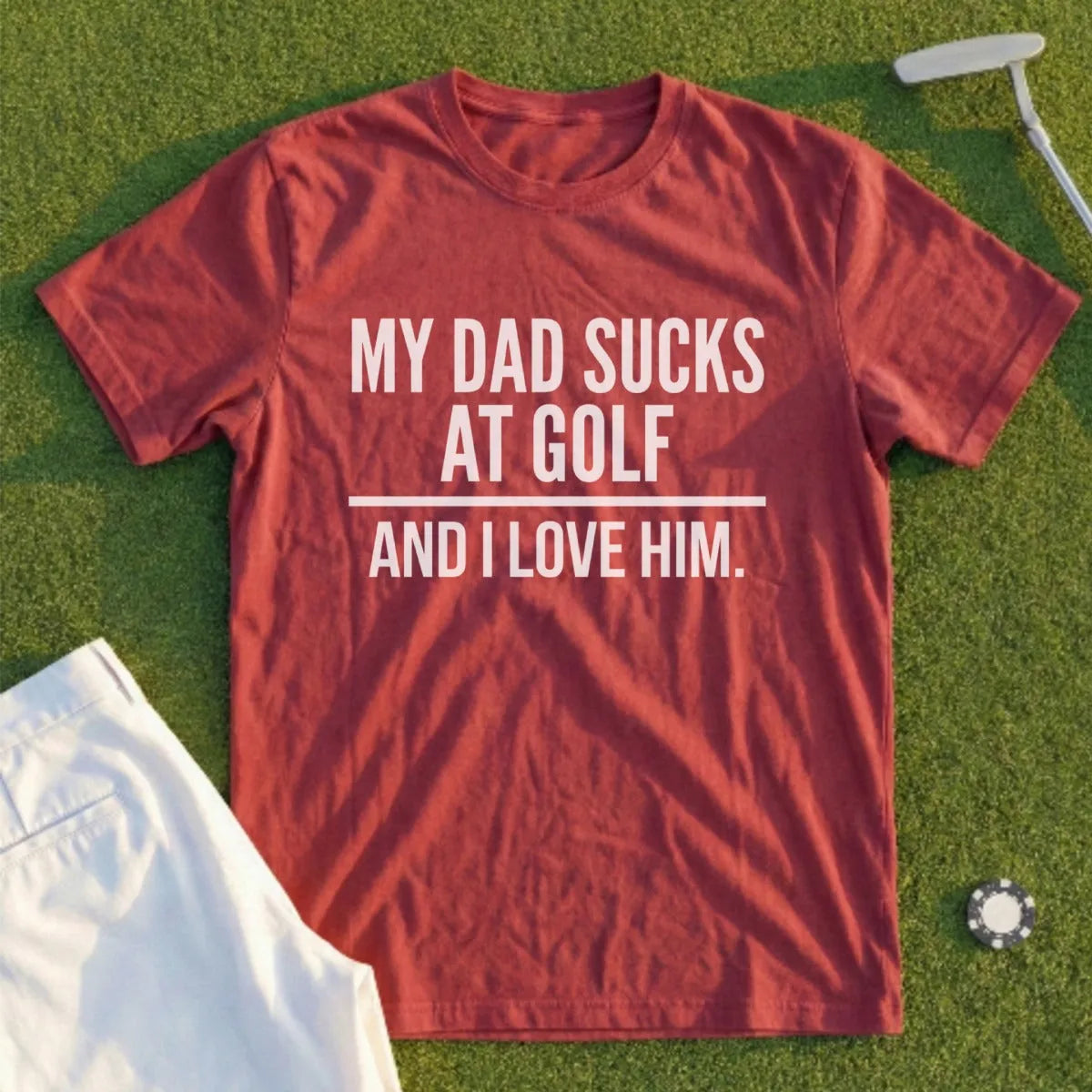 Red t-shirt with "MY DAD SUCKS AT GOLF AND I LOVE HIM." text.