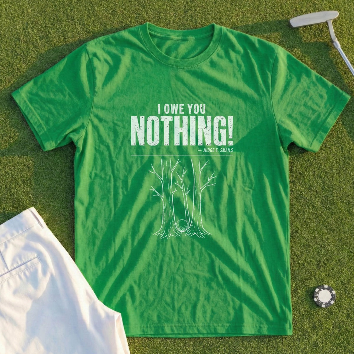 Green t-shirt with "I OWE YOU NOTHING! JUDGE E. SMAILS" and golf imagery.