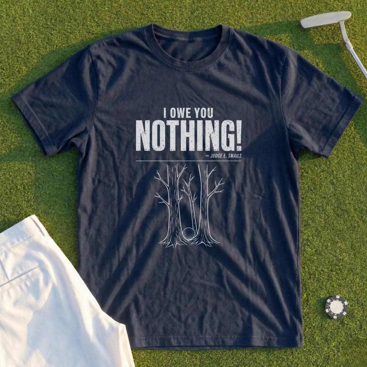 Navy t-shirt with "I OWE YOU NOTHING!" and golf ball in trees graphic.