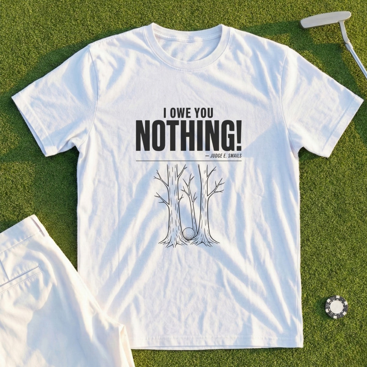 White t-shirt with "I OWE YOU NOTHING!" and a golf ball stuck in trees.