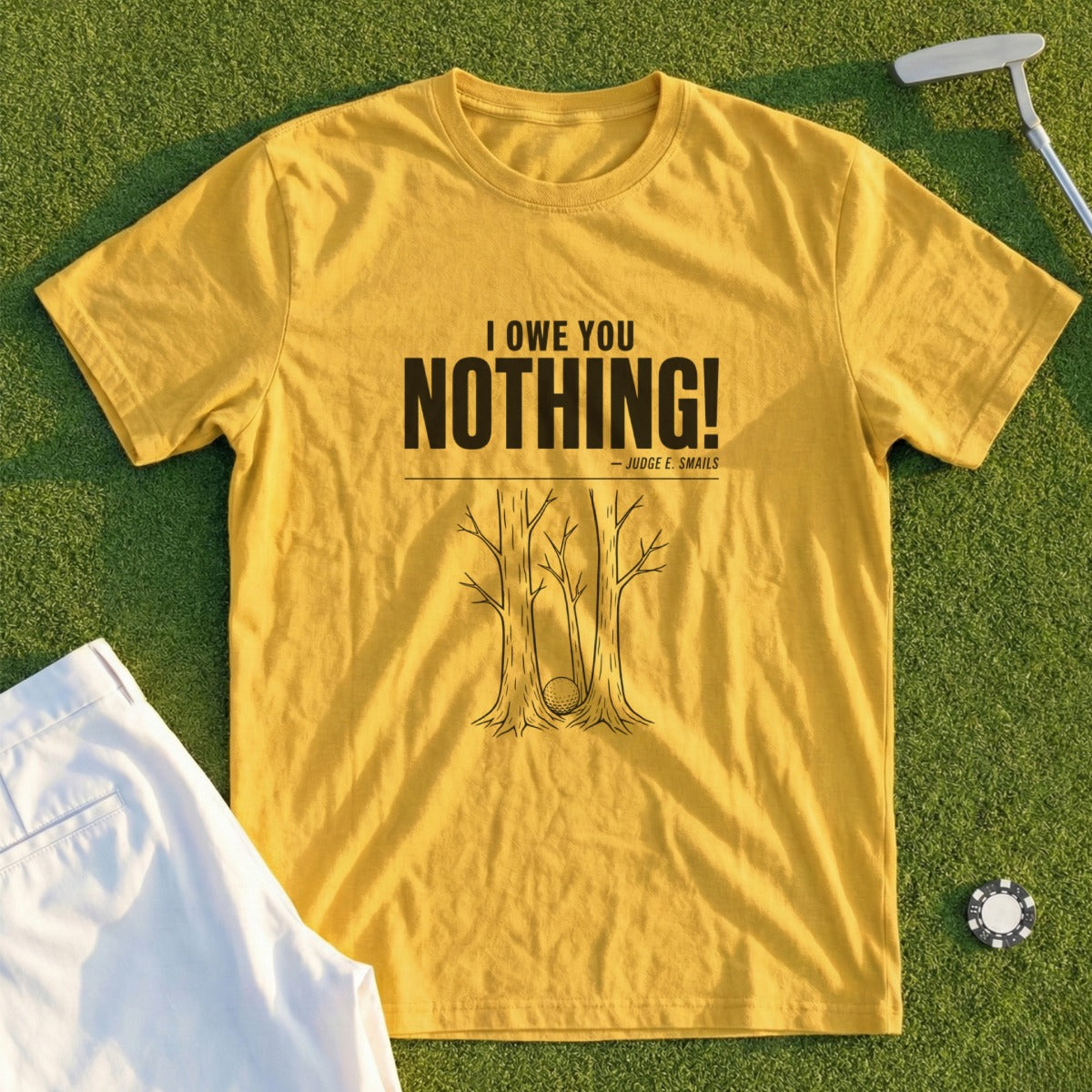 Yellow t-shirt with "I OWE YOU NOTHING!" and a golf ball stuck between trees.