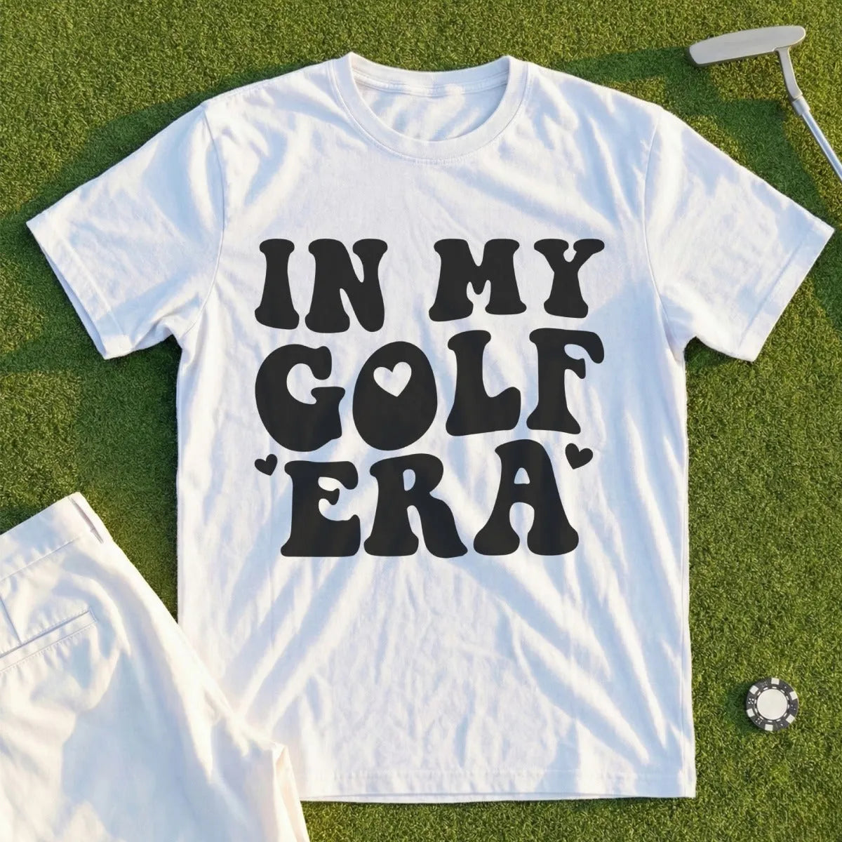 White t-shirt with "IN MY GOLF ERA" text and heart graphic.