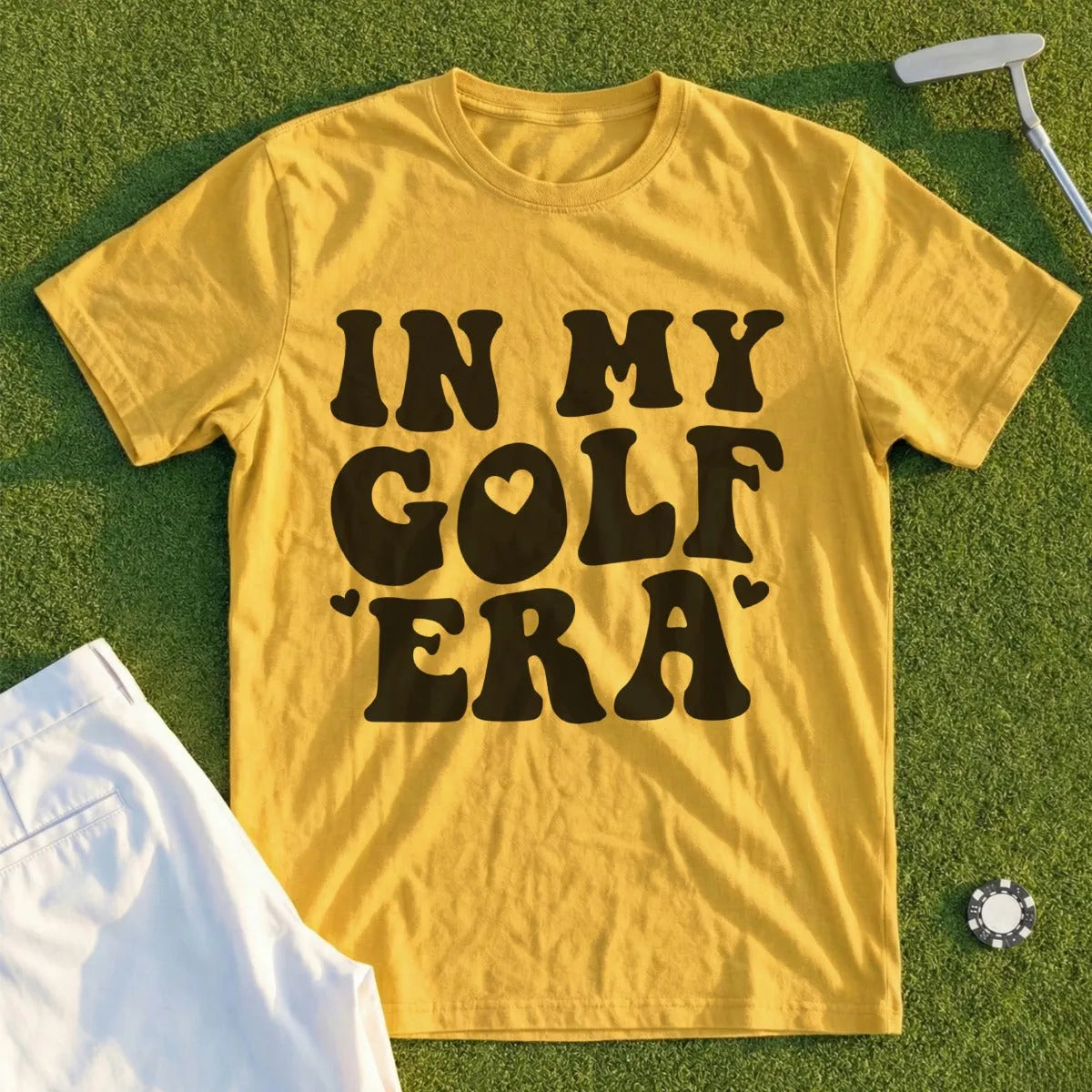 Yellow t-shirt with "In My Golf Era" text and heart graphic.