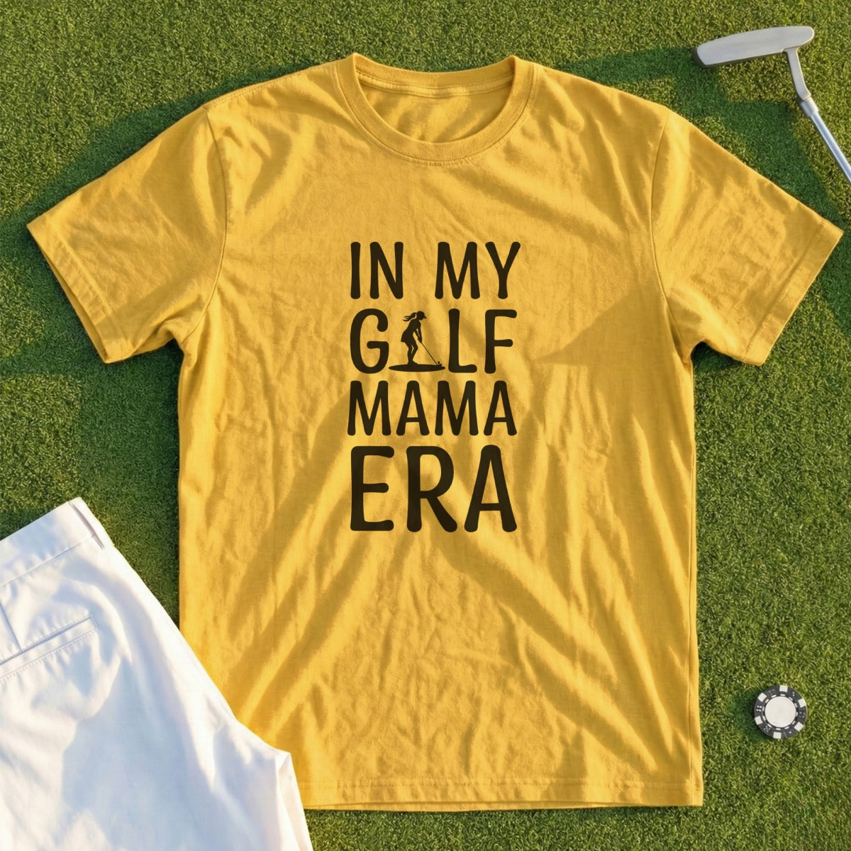Yellow t-shirt with "In My Golf Mama Era" text and golf accessories.