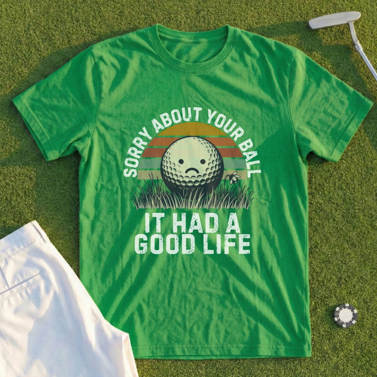 Green t-shirt with a sad golf ball and "SORRY ABOUT YOUR BALL IT HAD A GOOD LIFE" text.