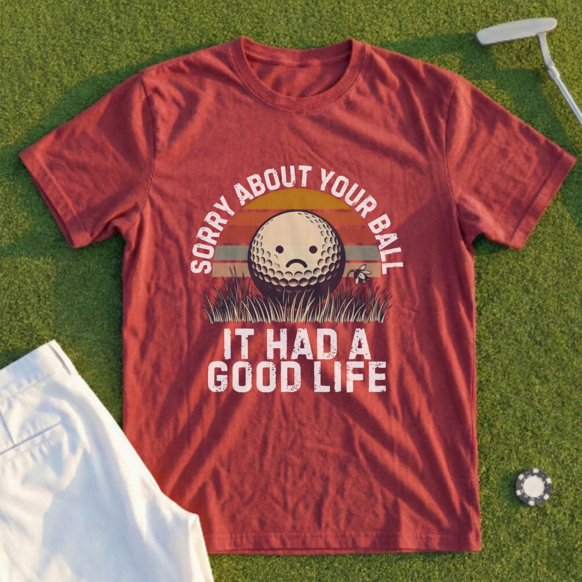 Maroon t-shirt with "Sorry About Your Ball It Had a Good Life" text and a sad golf ball graphic.