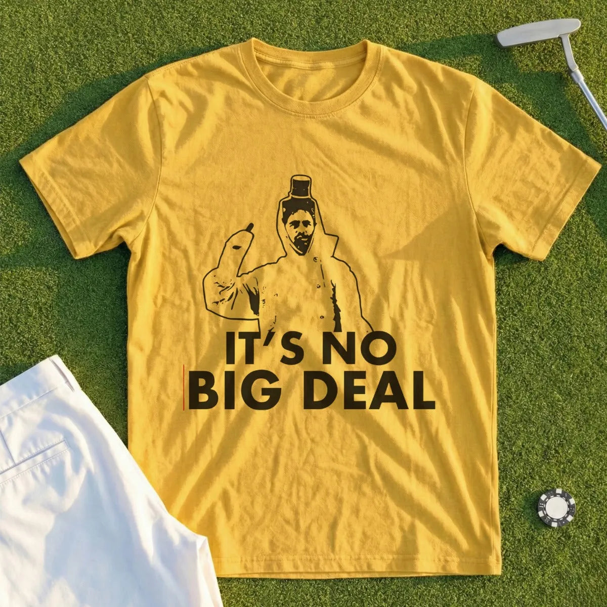 Yellow t-shirt with a graphic of a man in a raincoat and the text "IT'S NO BIG DEAL".
