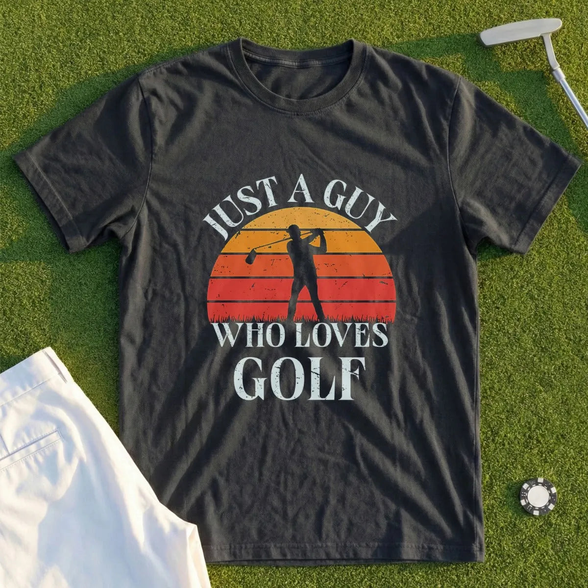 Dark t-shirt with sunset graphic and text: "JUST A GUY WHO LOVES GOLF".
