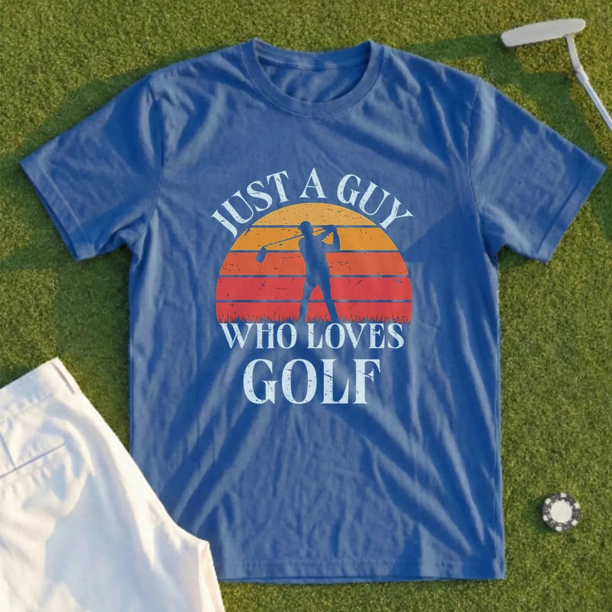 Blue t-shirt with "Just a Guy Who Loves Golf" and a golfer at sunset graphic.