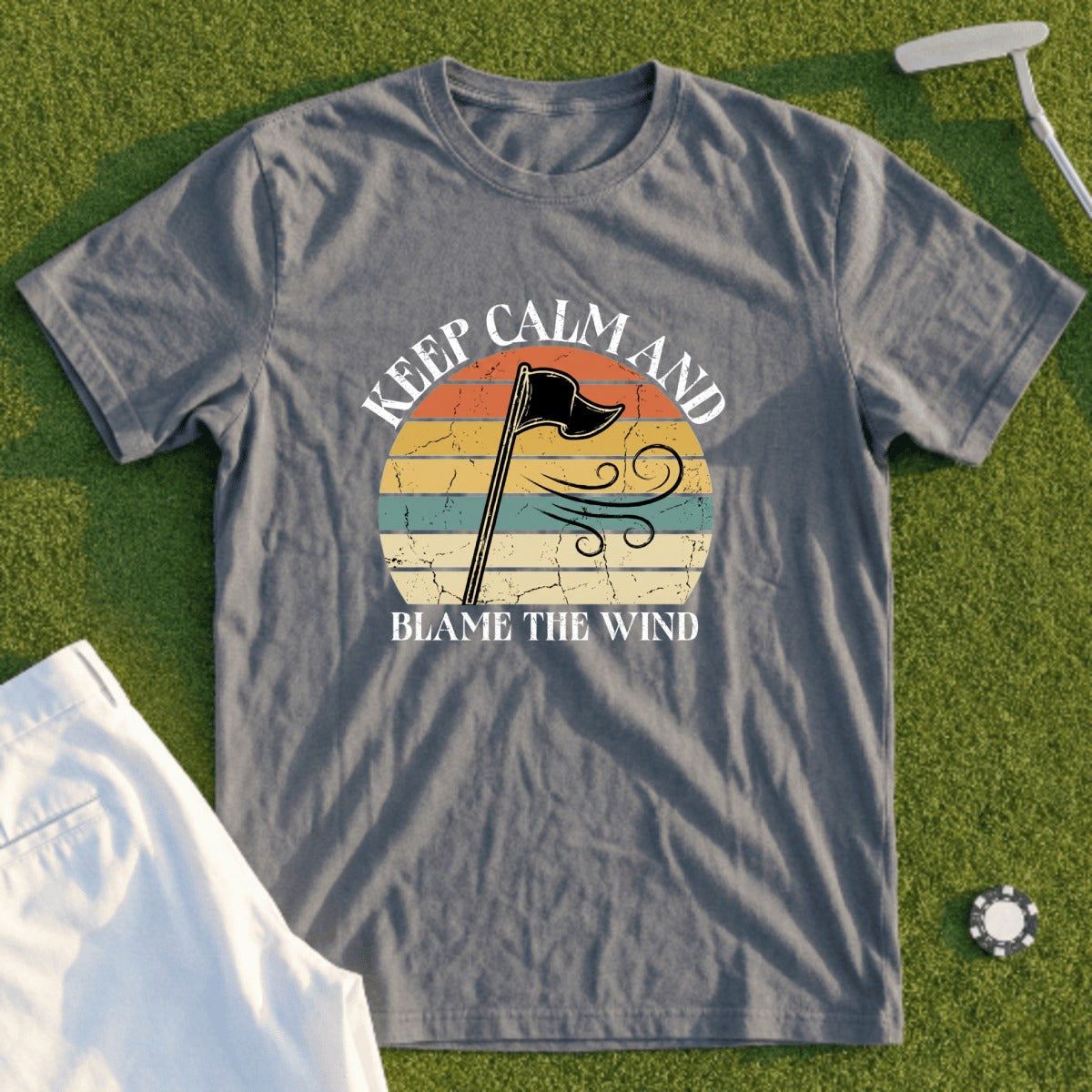 Grey t-shirt with "Keep Calm and Blame the Wind" text and a golf flag graphic.