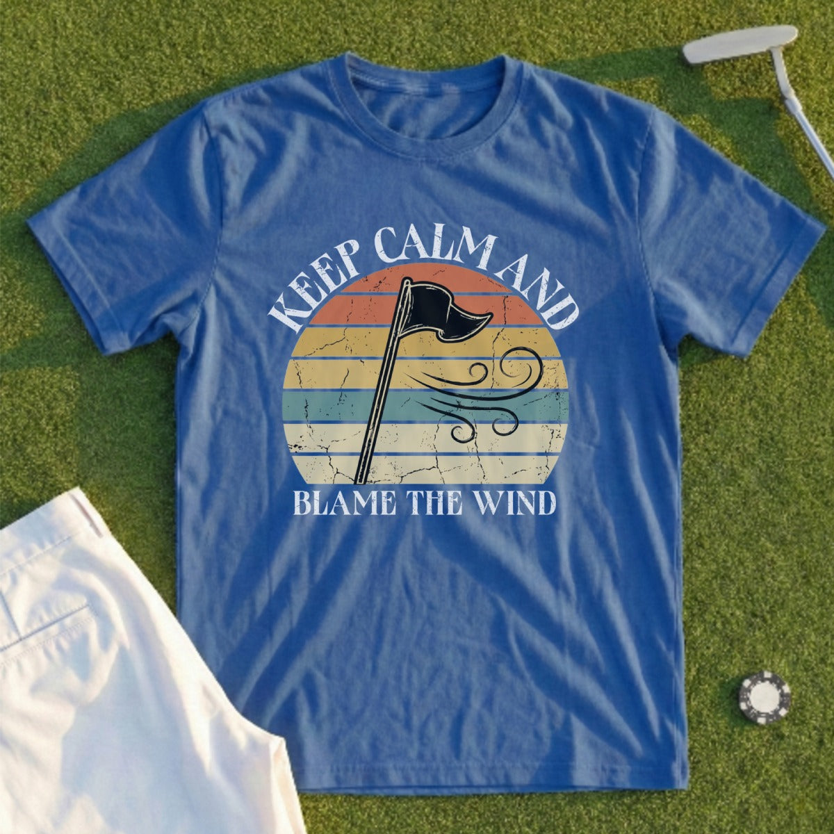 Blue t-shirt with "Keep Calm and Blame the Wind" text and vintage flag graphic.