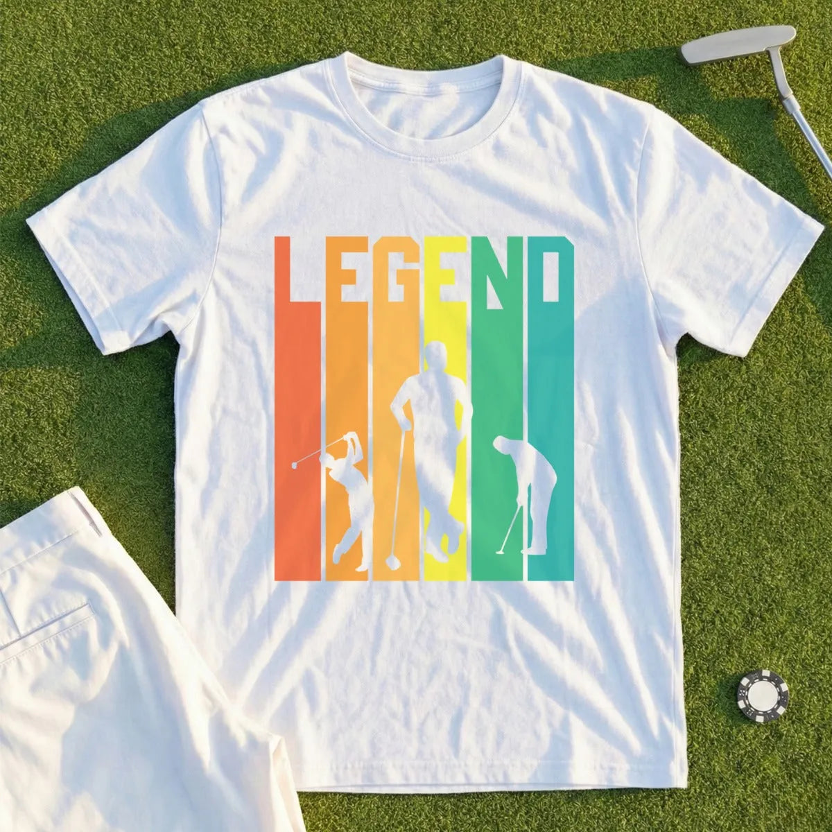 White t-shirt with "LEGEND" and golfer silhouettes on colorful striped background.
