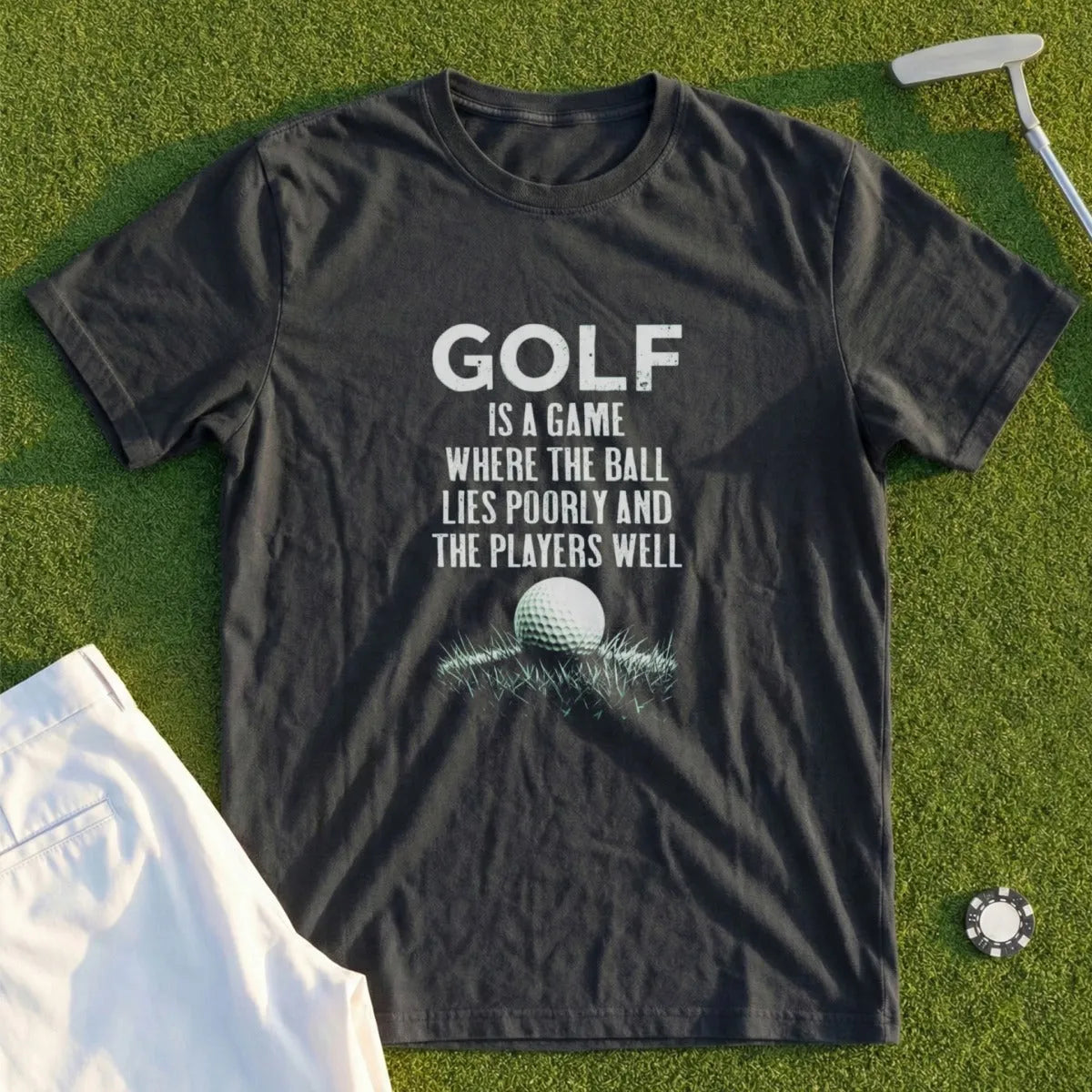 T-shirt with golf humor text "GOLF IS A GAME WHERE THE BALL LIES POORLY AND THE PLAYERS WELL" and golf ball.