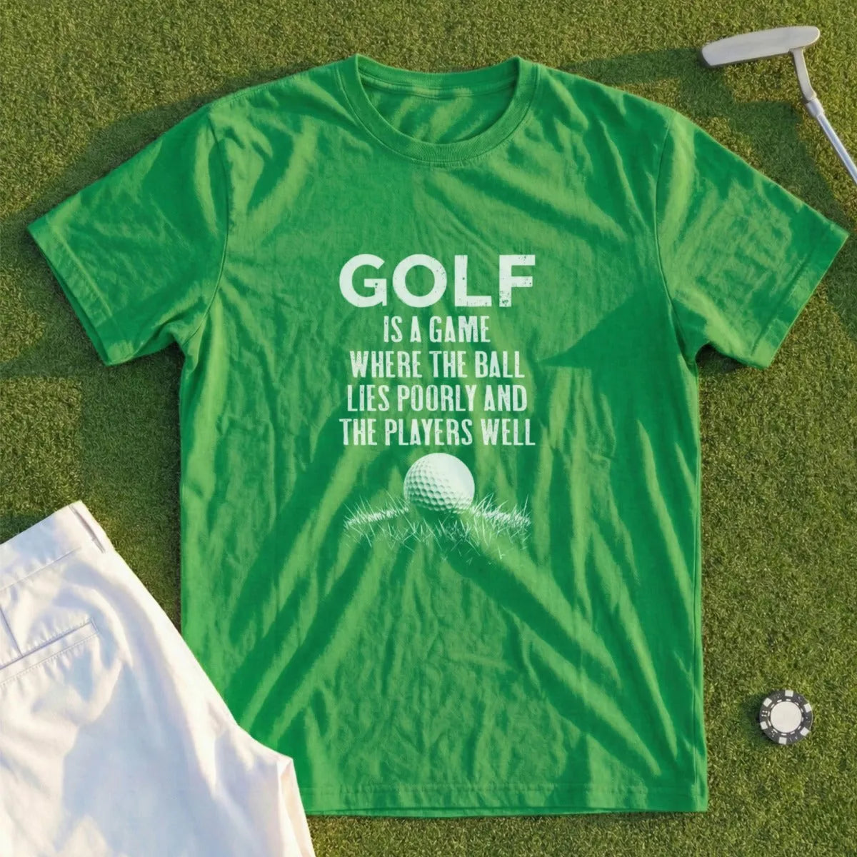 Green t-shirt with text "GOLF IS A GAME WHERE THE BALL LIES POORLY AND THE PLAYERS WELL".