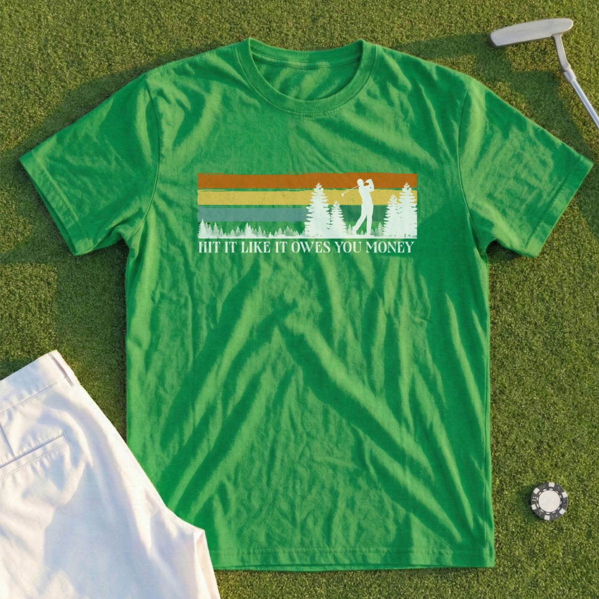 Green t-shirt with golfer silhouette and "HIT IT LIKE IT OWES YOU MONEY" text.