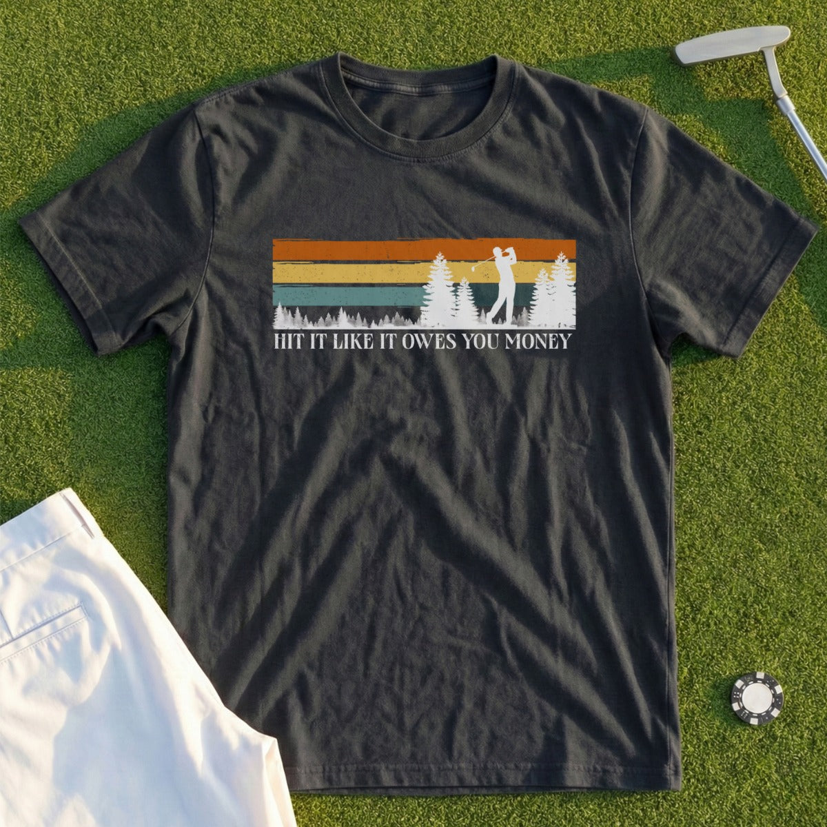 Dark t-shirt with vintage graphic of golfer and text "HIT IT LIKE IT OWES YOU MONEY".