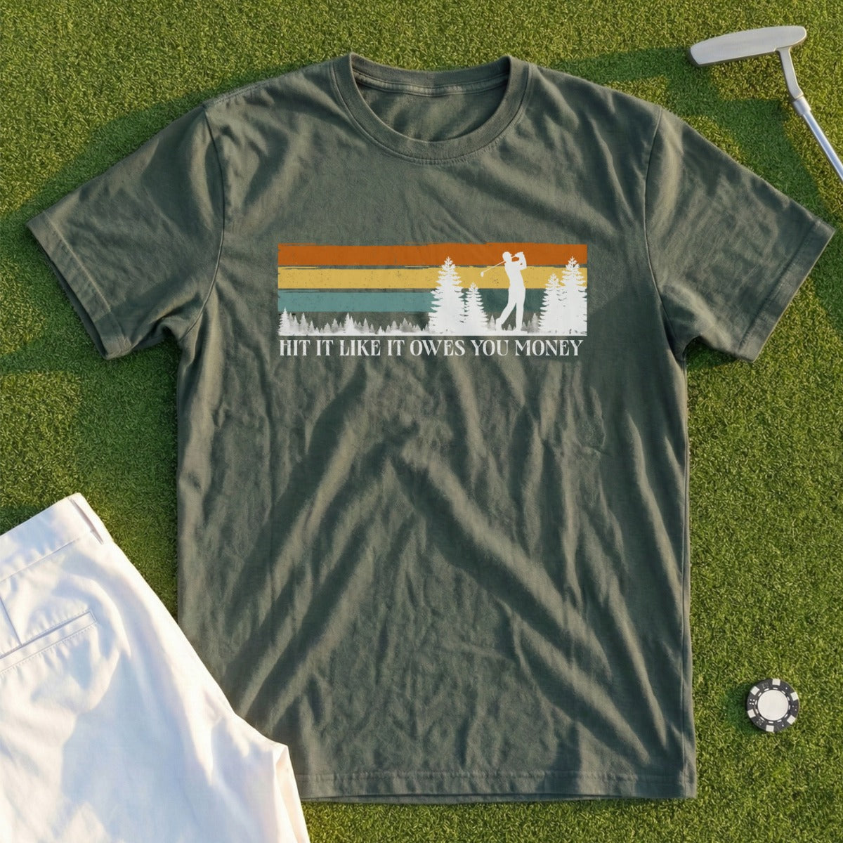 T-shirt with golfer silhouette and text "HIT IT LIKE IT OWES YOU MONEY".