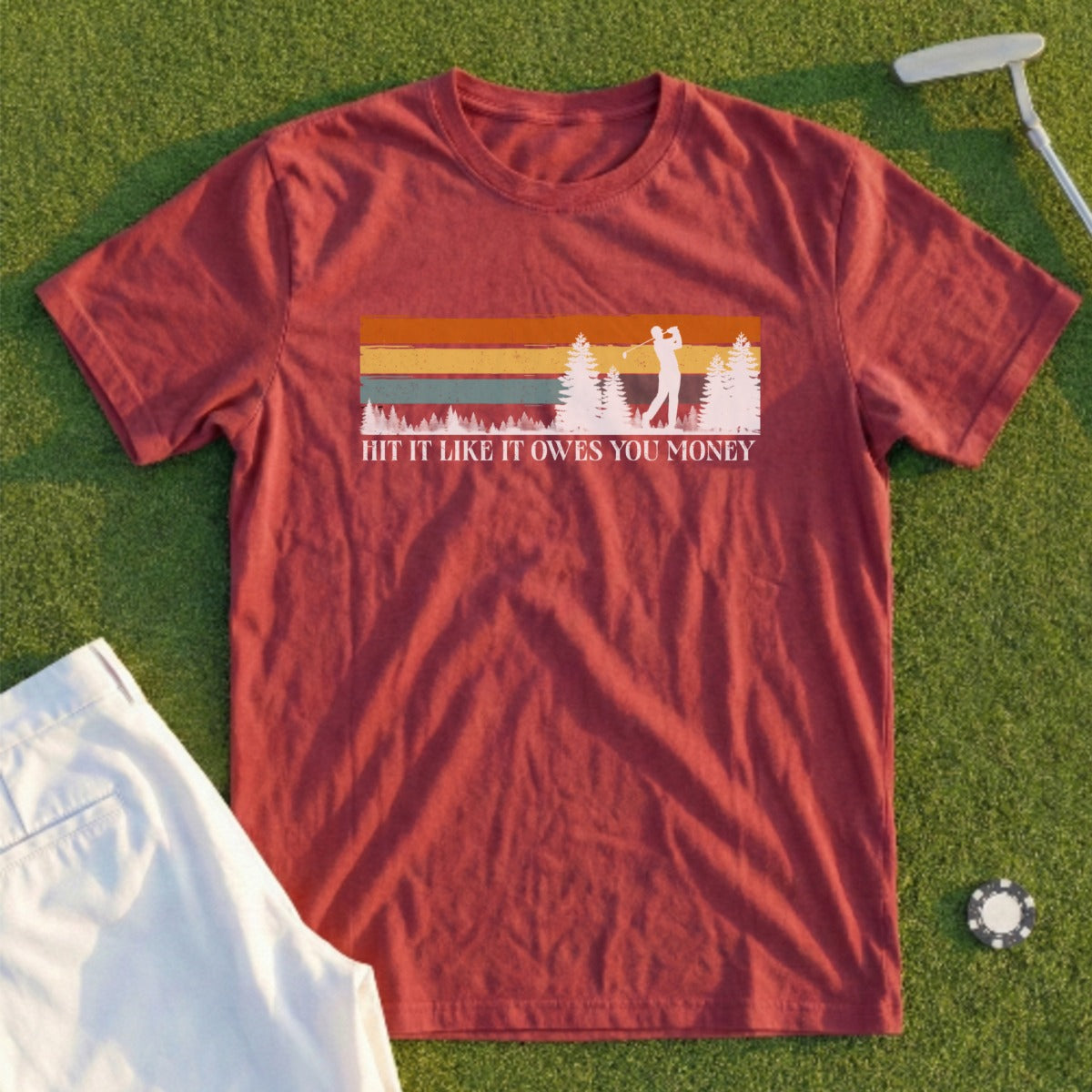 Maroon t-shirt with golfer graphic and text "Hit It Like You Own Money".