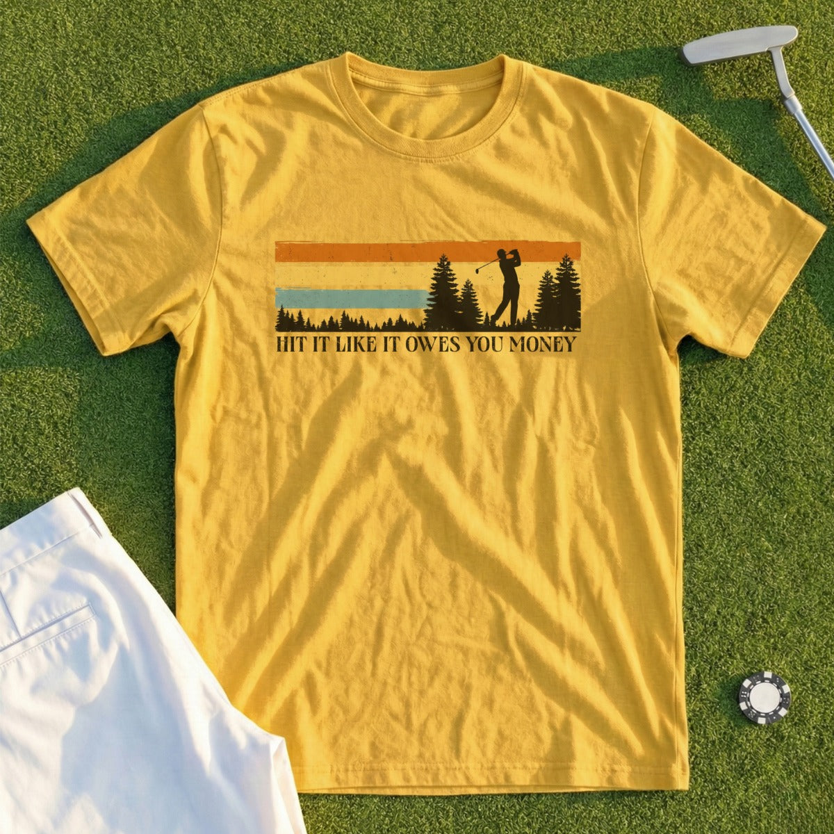 Yellow t-shirt with golfer silhouette and text "Hit It Like It Owes You Money".