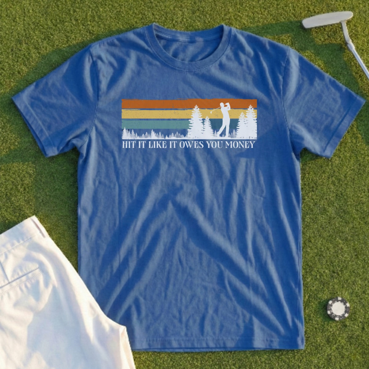 Blue t-shirt with golfer graphic and text "HIT IT LIKE IT OWES YOU MONEY".