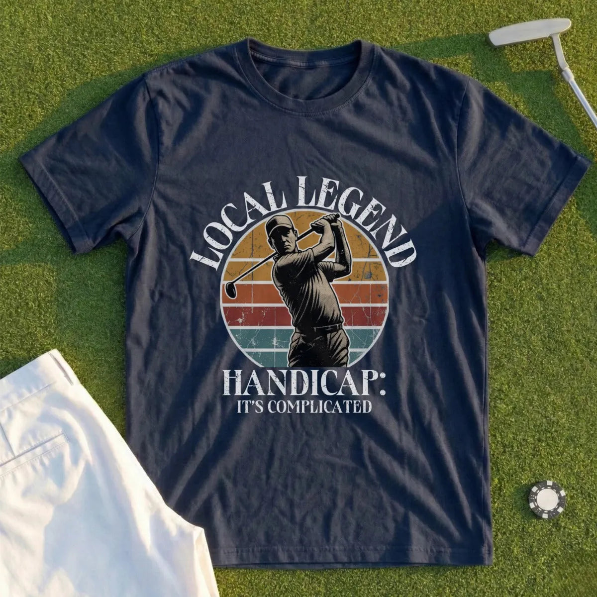 Navy t-shirt with a golfer mid-swing and text "LOCAL LEGEND HANDICAP: IT'S COMPLICATED".