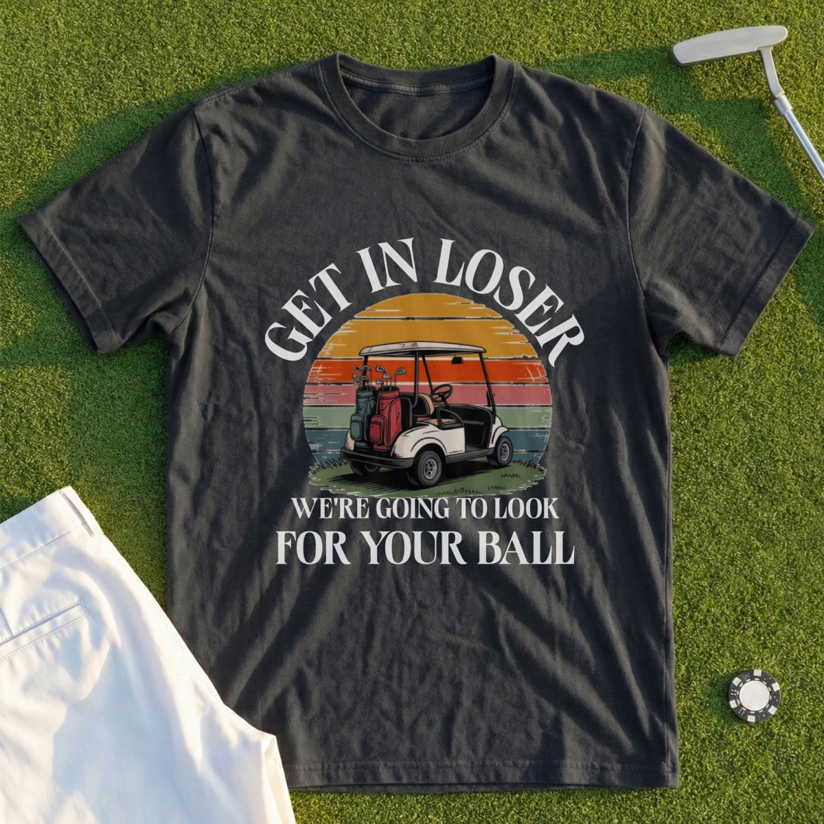Dark t-shirt with "Get in loser, we're going to look for your ball" and golf cart graphic.