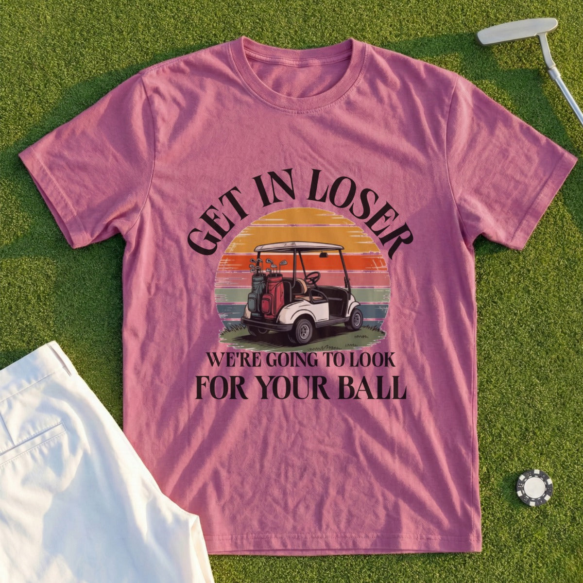 Pink t-shirt with "GET IN LOSER WE'RE GOING TO LOOK FOR YOUR BALL" and golf cart graphic.