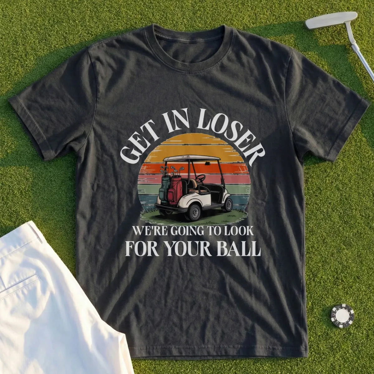 Dark t-shirt with "Get in loser, we're going to look for your ball" and golf cart graphic.