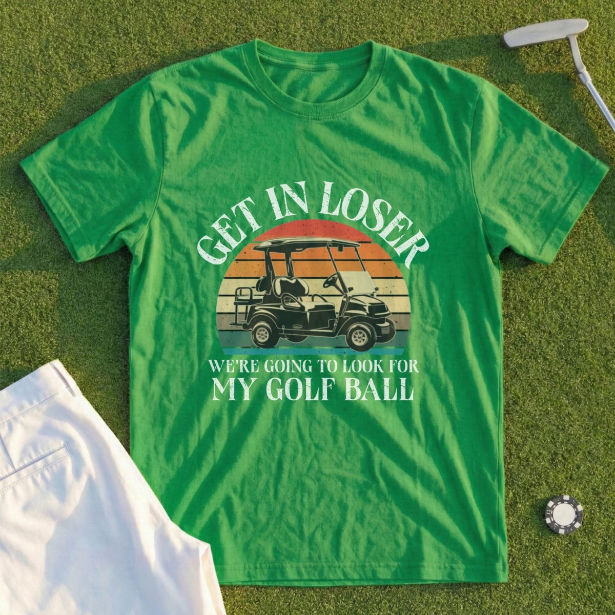 Green t-shirt with "GET IN LOSER WE'RE GOING TO LOOK FOR MY GOLF BALL" and golf cart graphic.