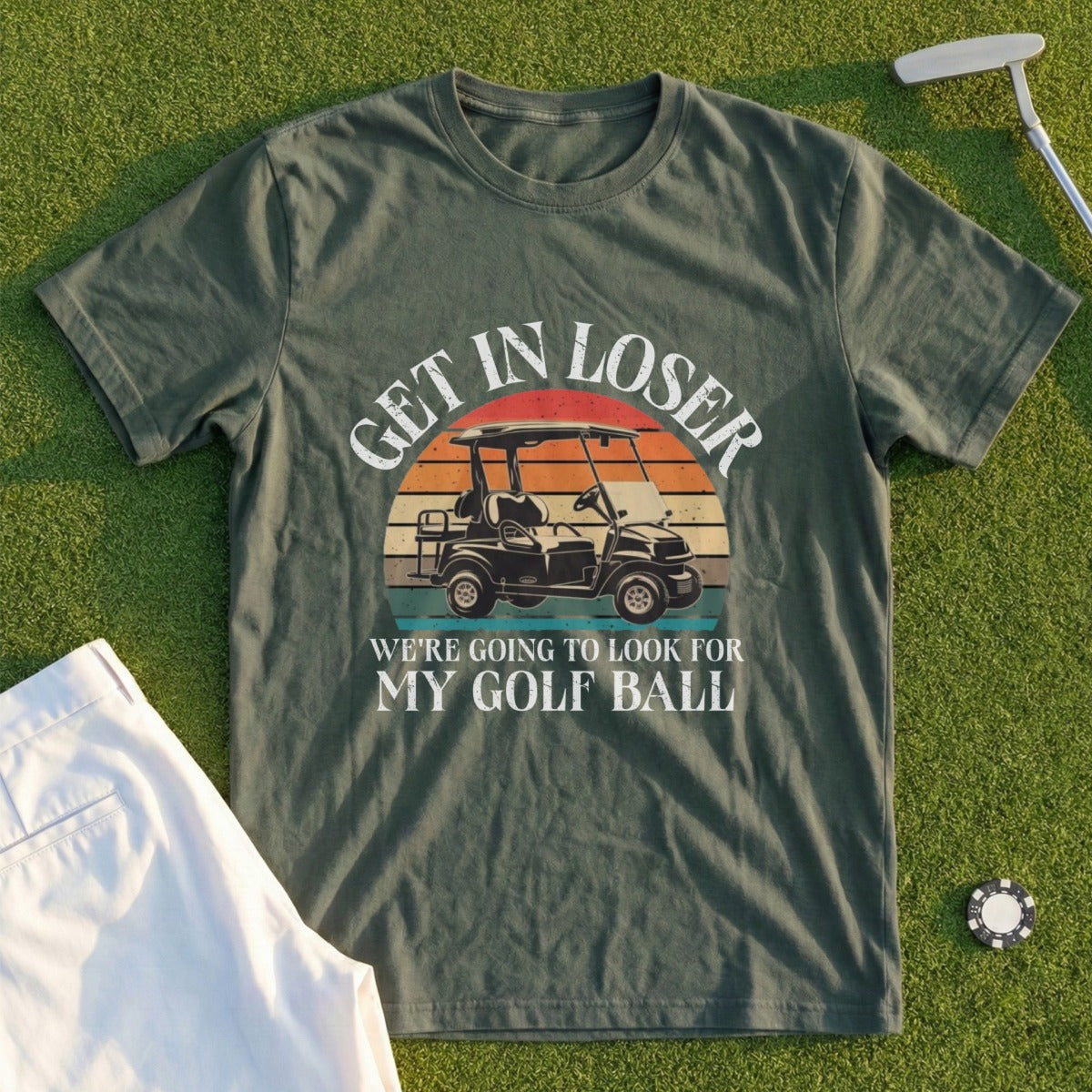 Green t-shirt with "GET IN LOSER WE'RE GOING TO LOOK FOR MY GOLF BALL" and a golf cart graphic.