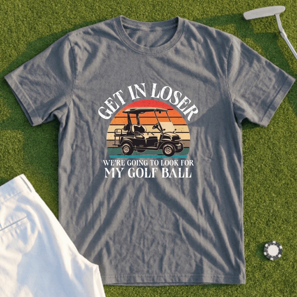 Gray t-shirt with "Get in loser, we're going to look for my golf ball" text and golf cart graphic.