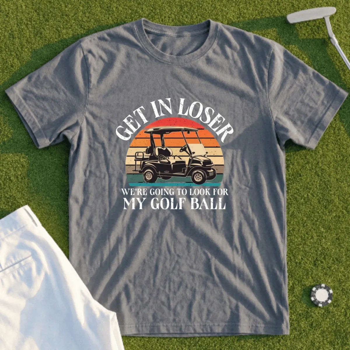 Gray t-shirt with "Get in loser, we're going to look for my golf ball" text and golf cart graphic.