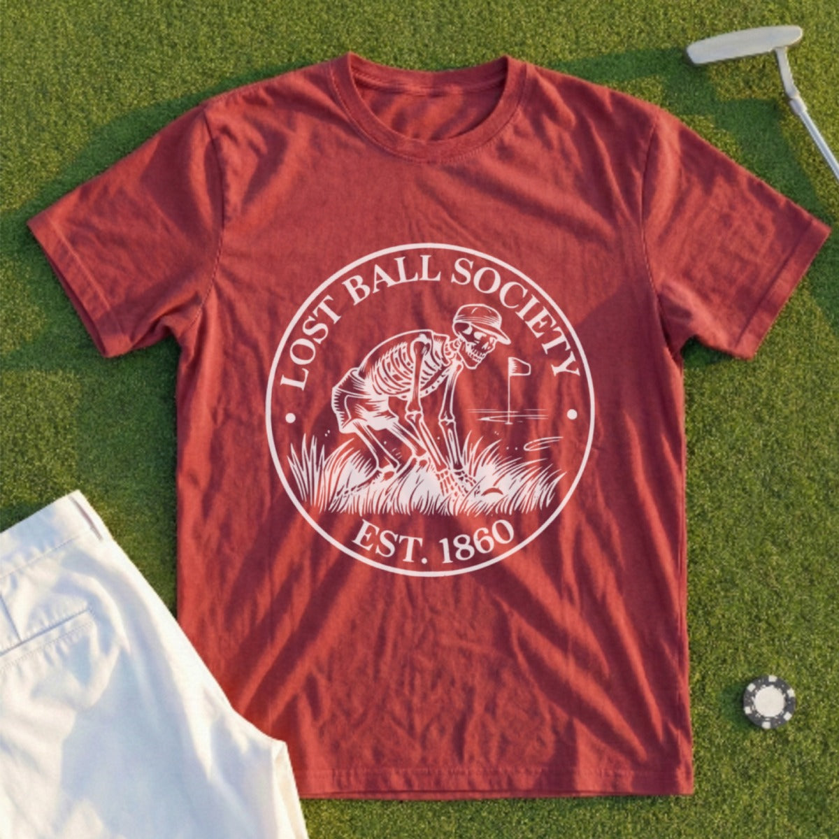 Maroon t-shirt with circular logo "LOST BALL SOCIETY EST. 1860" featuring a skeleton golfing.