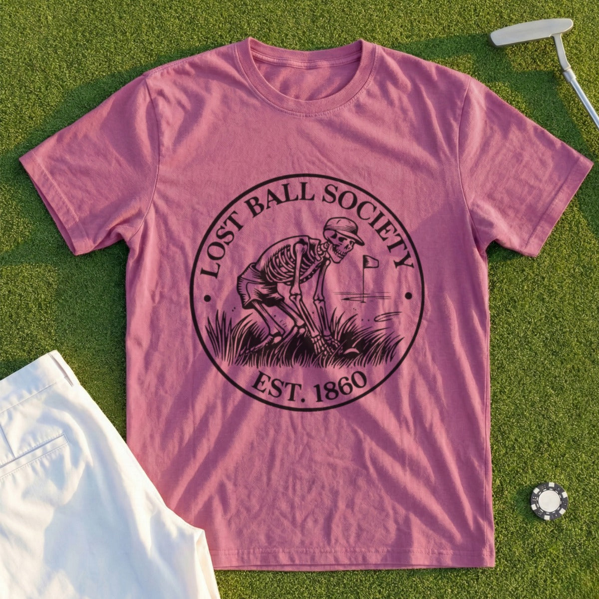 Pink t-shirt with "Lost Ball Society Est. 1860" logo featuring a skeleton golfing.