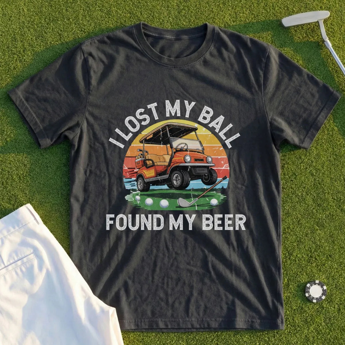 Dark t-shirt with graphic of golf cart, golf balls, and text "I lost my ball, found my beer".