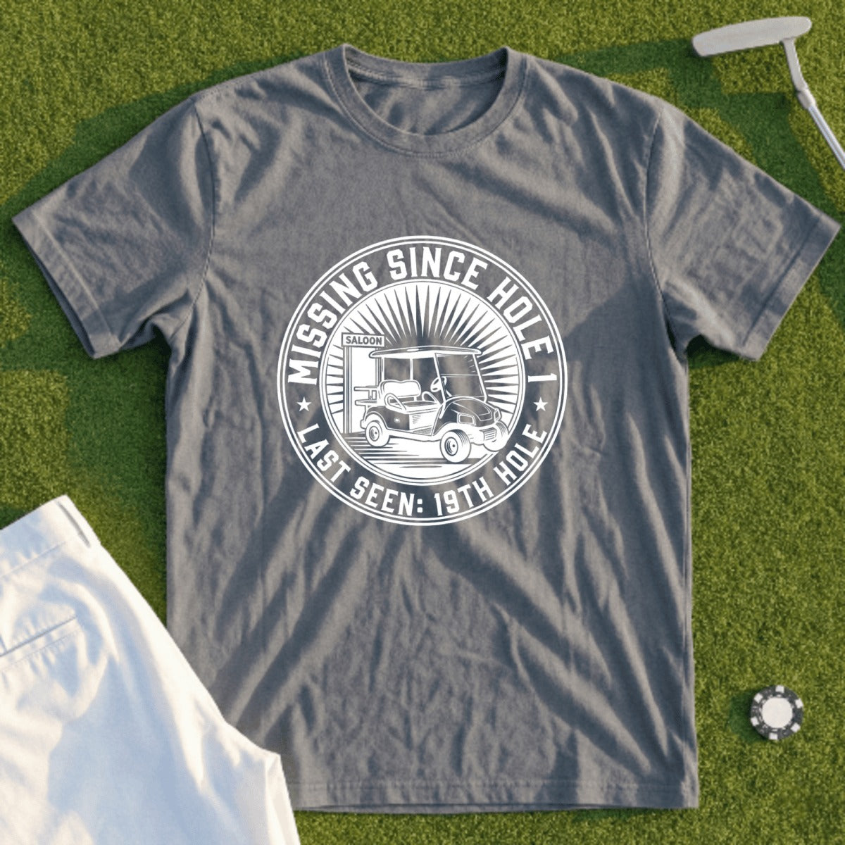 Grey t-shirt with "Missing Since Last Seen: 19th Hole" text and golf cart graphic.