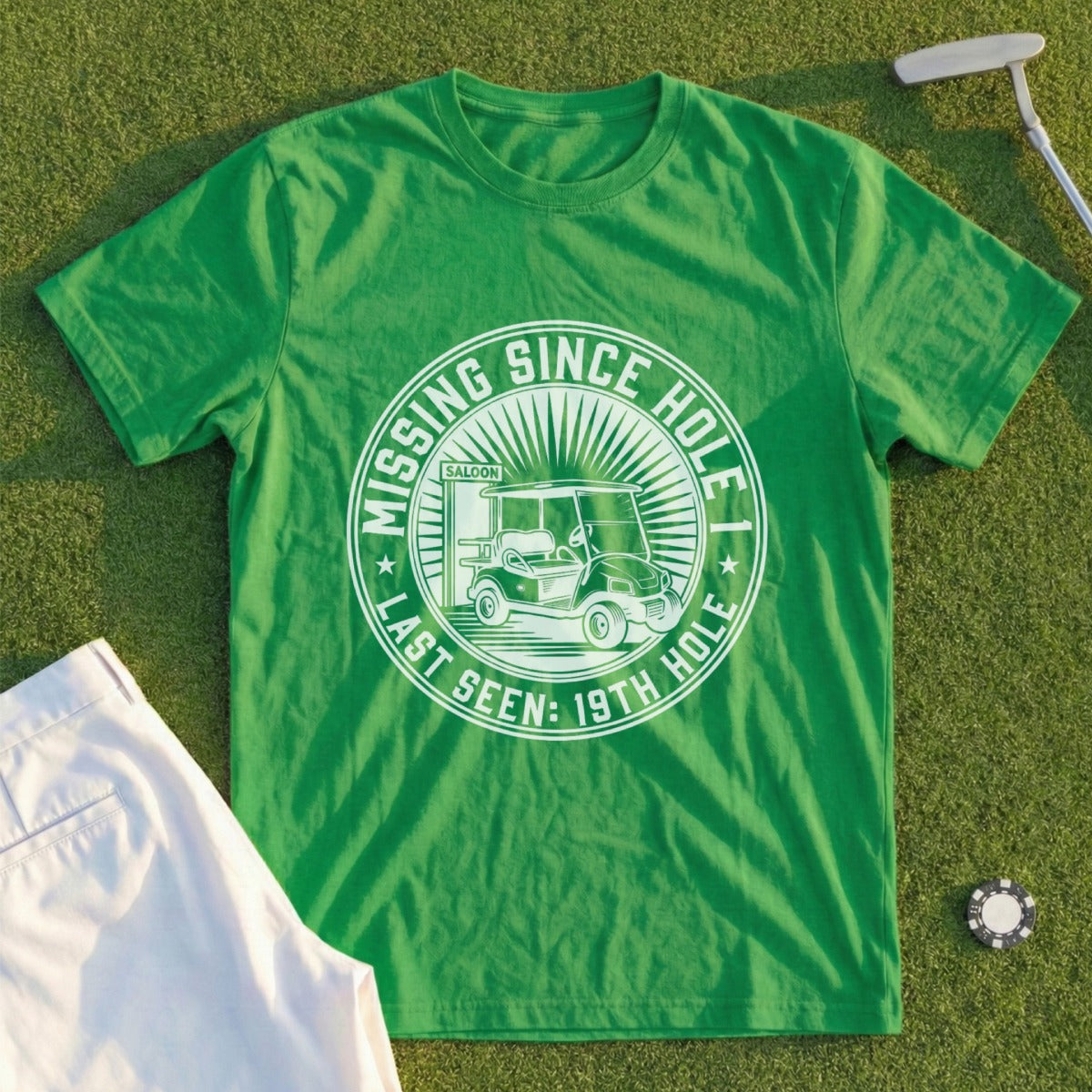 Green t-shirt with "Missing Since Last Seen: 19th Hole Saloon" text and golf cart graphic.
