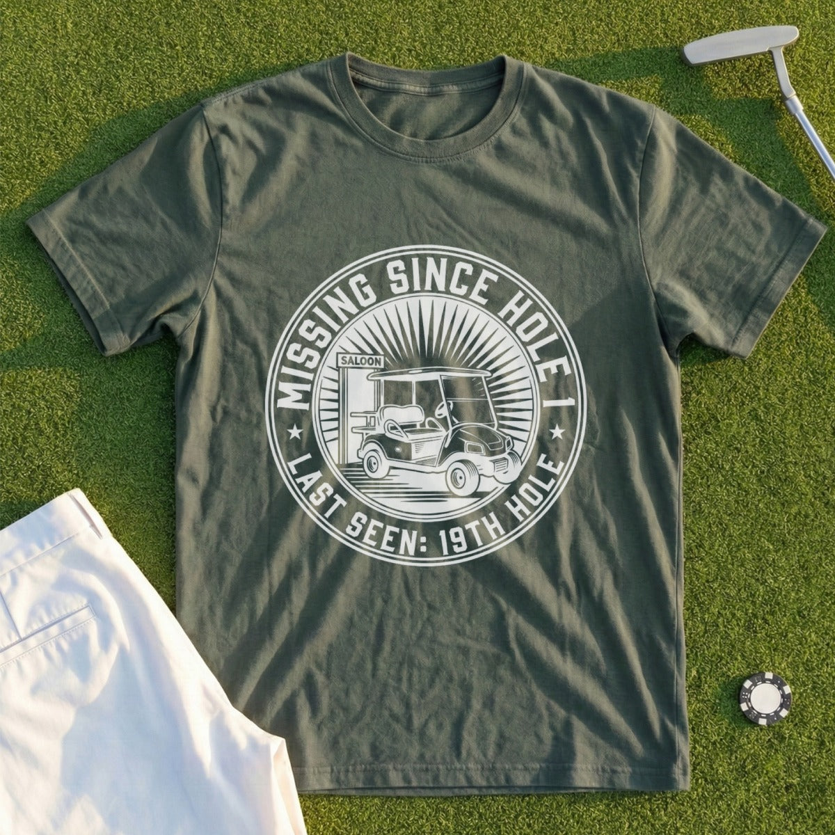 Olive green t-shirt with "Missing Since Hole Last Seen: 19th Hole" and golf cart graphic.