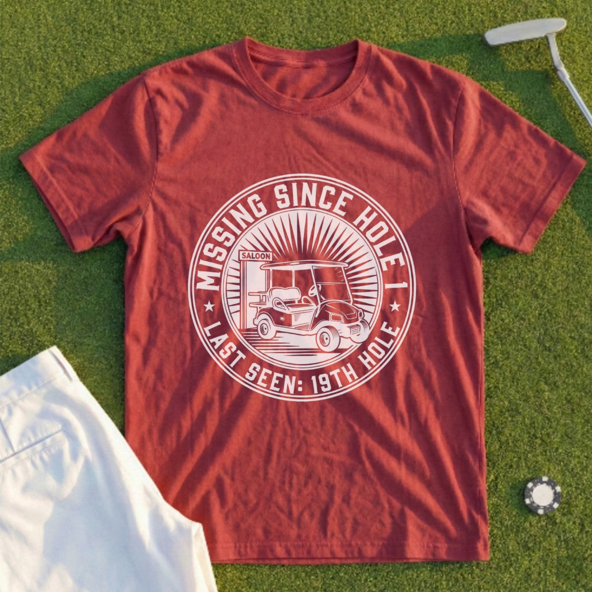 Maroon t-shirt with "Missing Since Last Seen: 19th Hole" graphic and golf cart.