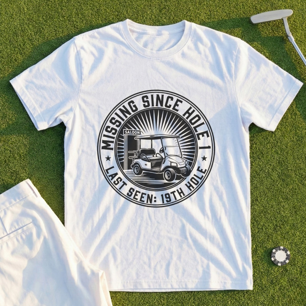 White t-shirt with graphic "Missing Since Last Seen: 19th Hole Saloon" and golf cart.