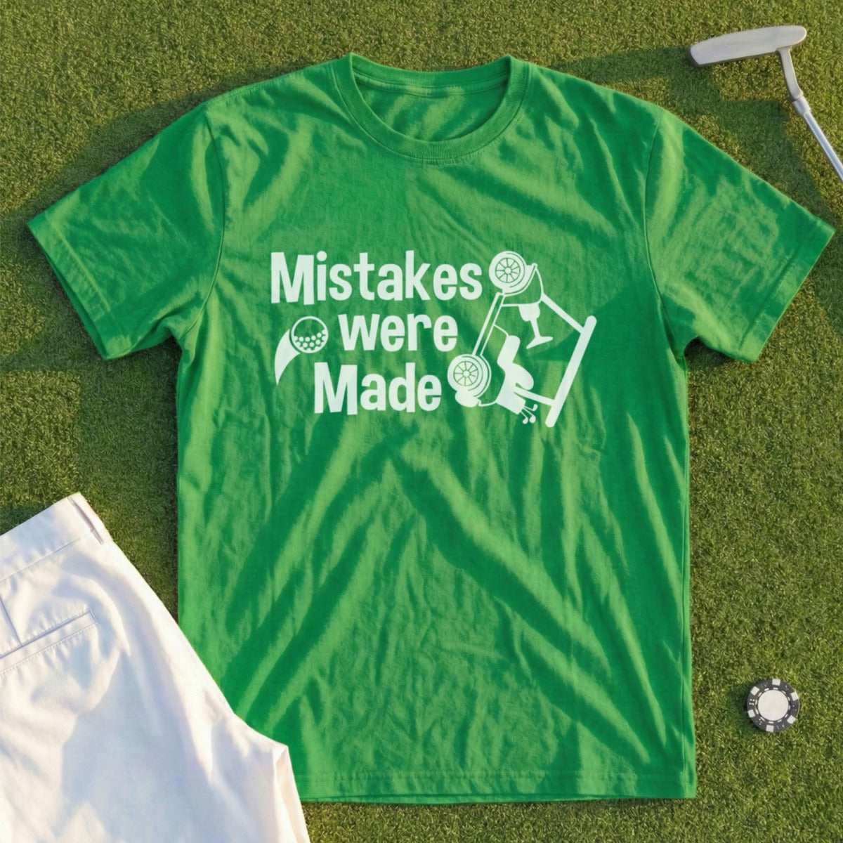 Green t-shirt with white text and graphic of golf ball and overturned car.
