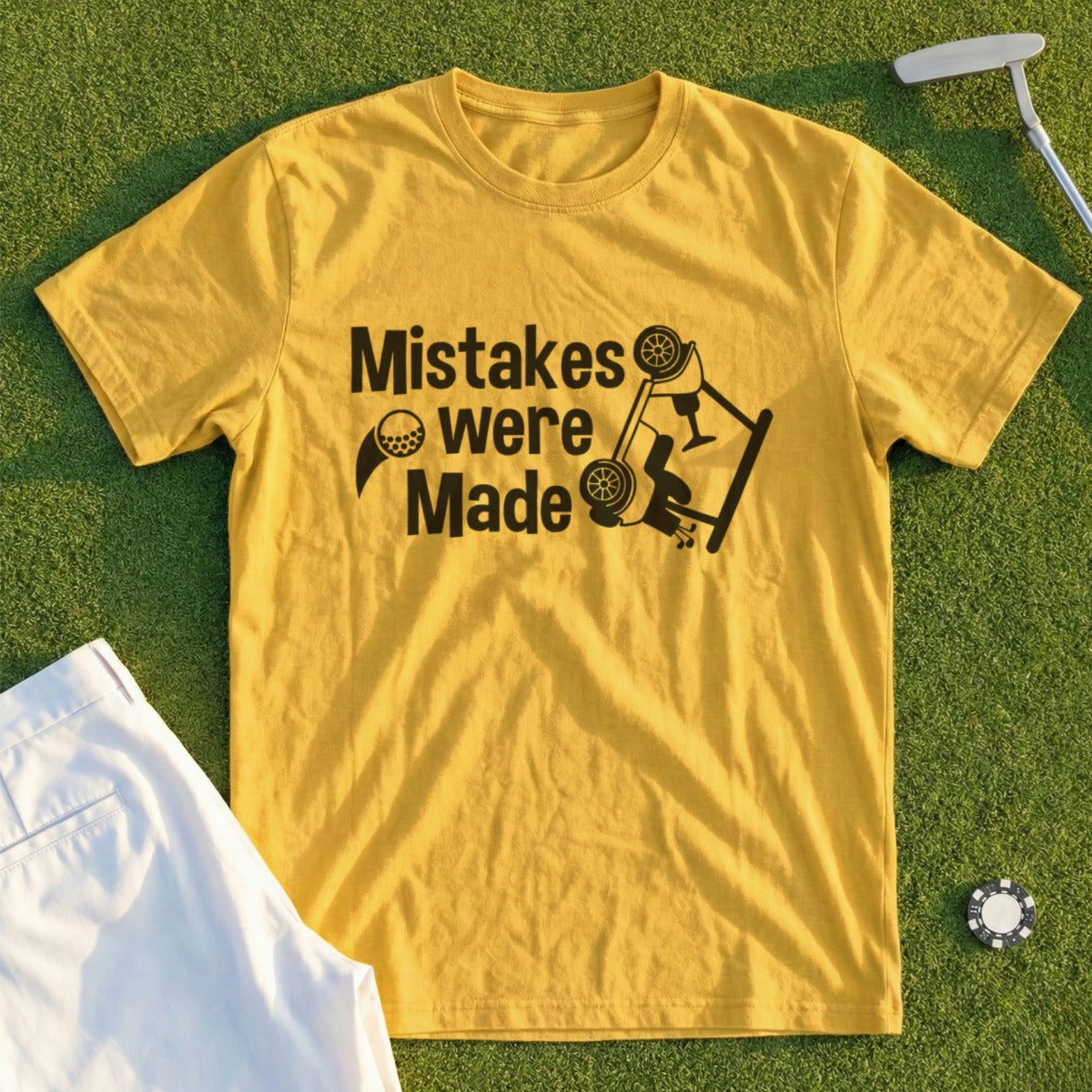 Yellow t-shirt with text "Mistakes were Made" and a golf ball.