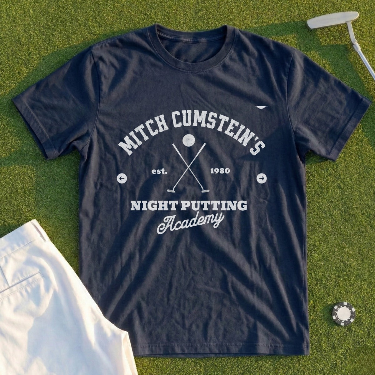 Navy t-shirt with "Mitch Cumstein's Night Putting Academy" text and golf elements.