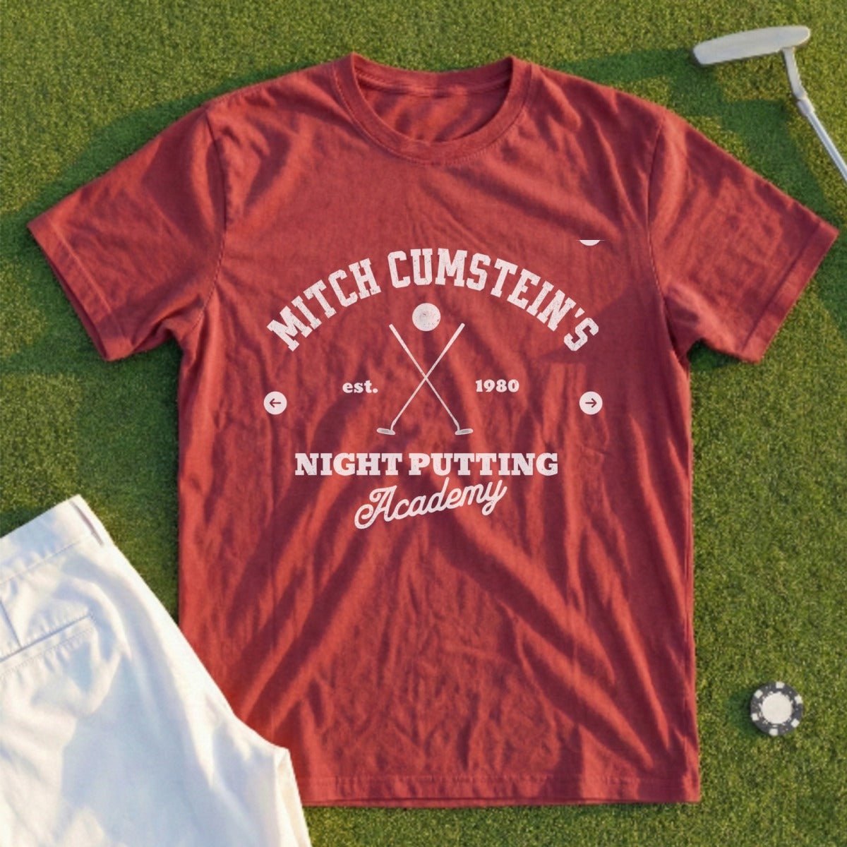 Red t-shirt with "Mitch Cumstein's Night Putting Academy est. 1980" text.