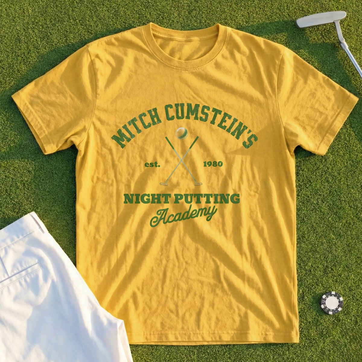 Yellow t-shirt with "Mitch Cumstein's Night Putting Academy est. 1980" graphic.