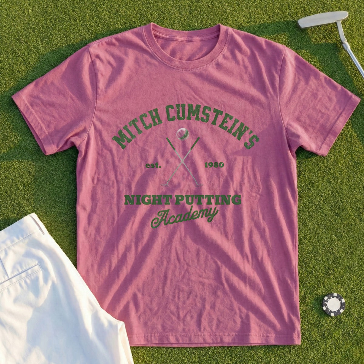 Pink t-shirt with "Mitch Cumstein's Night Putting Academy" logo.