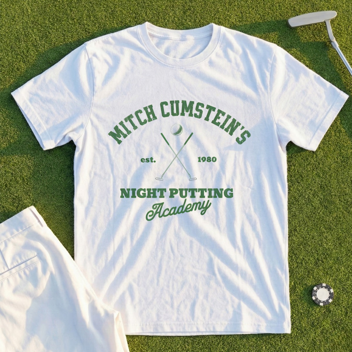 Mitch Cumstein's Night Putting Academy t-shirt with crossed golf clubs graphic.