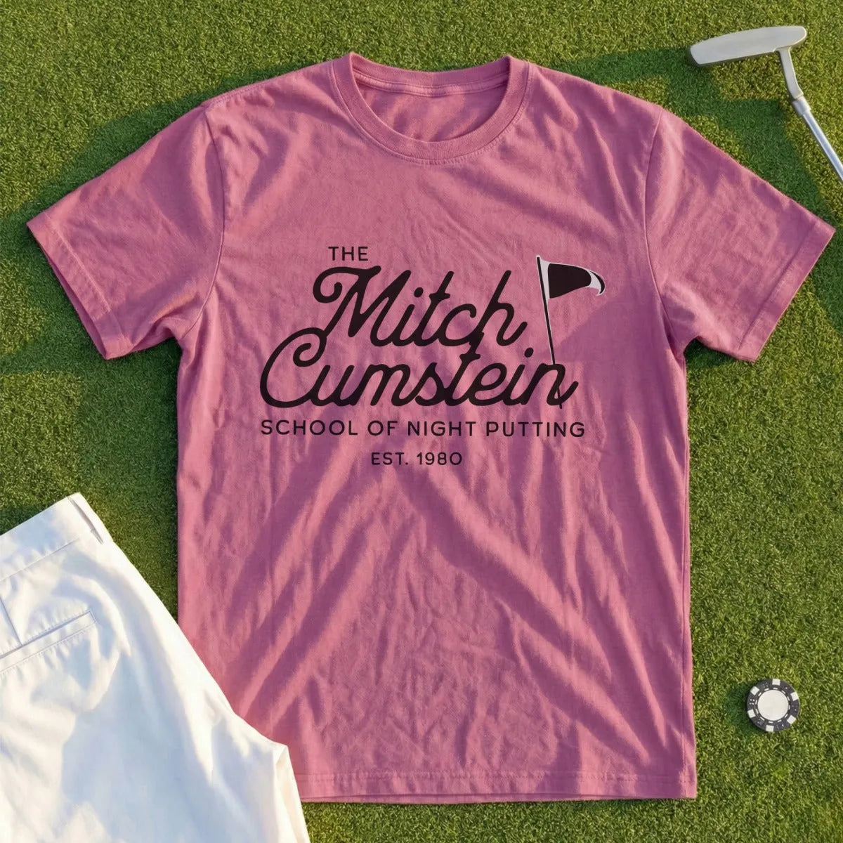 Pink t-shirt with "Mitch Cumstein School of Night Putting EST. 1980" text.